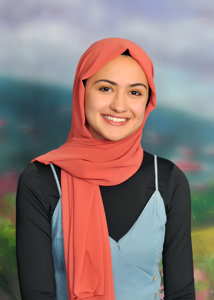 A smiling person wearing a headscarf