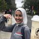 Laila Abd Elmagid headshot smiling holding a coffee