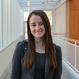 Hannah Castelo headshot smiling in building